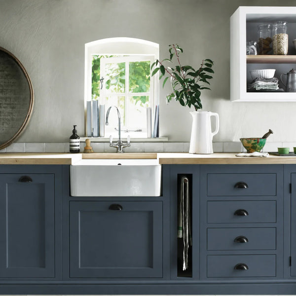 Blakeney Blue painted Henley kitchen cabinetry with oak worktops and a white farmhouse sink.
