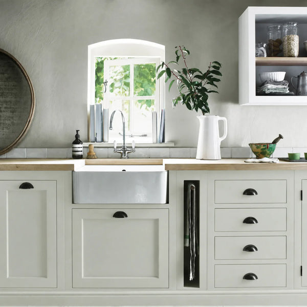 Powder Blue painted Henley kitchen cabinetry with oak worktops and a white farmhouse sink.