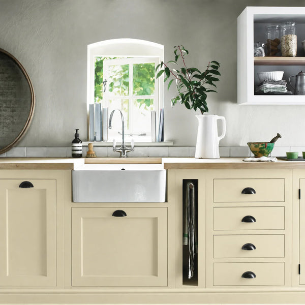 Old Chalk cream painted Henley kitchen cabinetry with oak worktops and a white farmhouse sink.