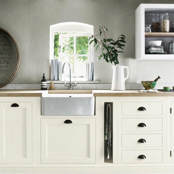 Snow white painted Henley kitchen cabinetry with oak worktops and a white farmhouse sink.