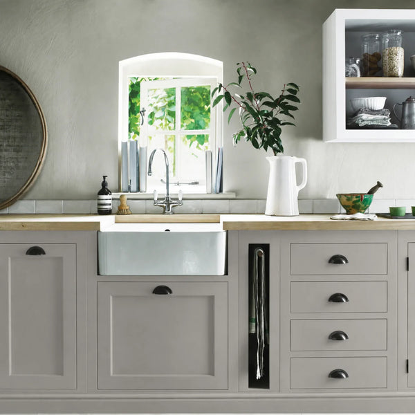 Cobble grey painted Henley kitchen cabinetry with oak worktops and a white farmhouse sink.