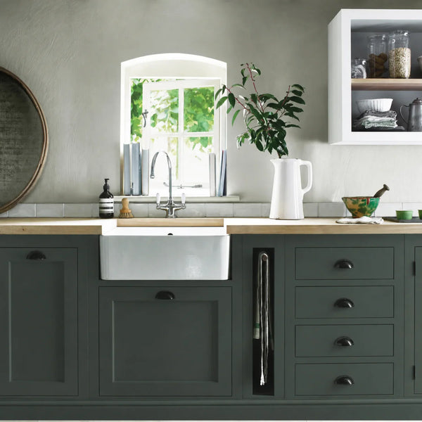 Charcoal grey painted Henley kitchen cabinetry with oak worktops and a white farmhouse sink.