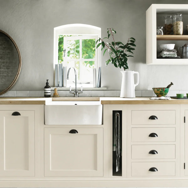 Salt White cream painted Henley kitchen cabinetry with oak worktops and a white farmhouse sink.