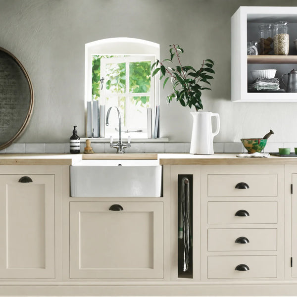 Silver Birch cream beige painted Henley kitchen cabinetry with oak worktops and a white farmhouse sink.