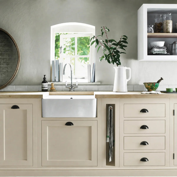 Dove Grey painted Henley kitchen cabinetry with oak worktops and a white farmhouse sink.