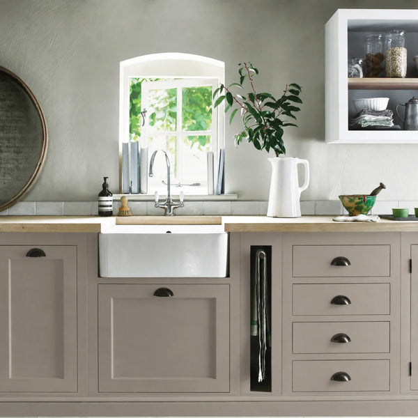 Grey Oak painted Henley kitchen cabinetry with oak worktops and a white farmhouse sink.