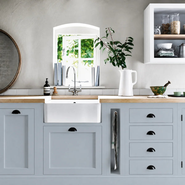 Flax Blue painted Henley kitchen cabinetry with oak worktops and a white farmhouse sink.