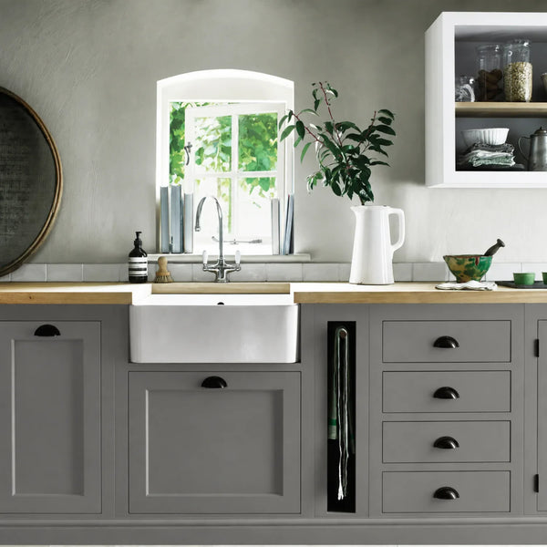 Shale grey painted Henley kitchen cabinetry with oak worktops and a white farmhouse sink.