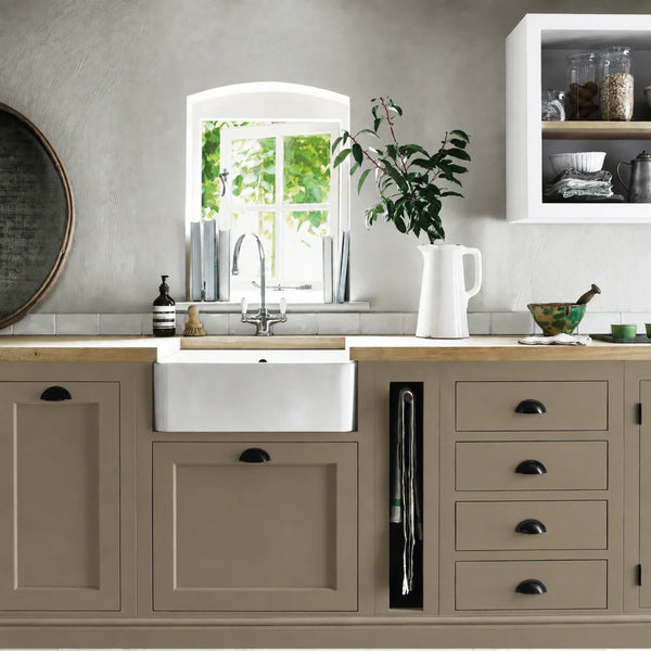 Lead Light brown beige painted Henley kitchen cabinetry with oak worktops and a white farmhouse sink.