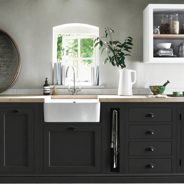 Warm Black painted Henley kitchen cabinetry with oak worktops and a white farmhouse sink.