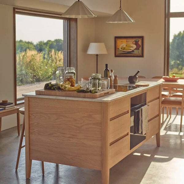 Borough freestanding oak kitchen island with marble worktop, integrated oven and surrounding dining area.