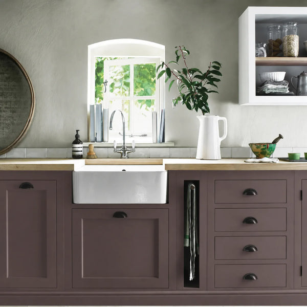 Clove plum painted Henley kitchen cabinetry with oak worktops and a white farmhouse sink.