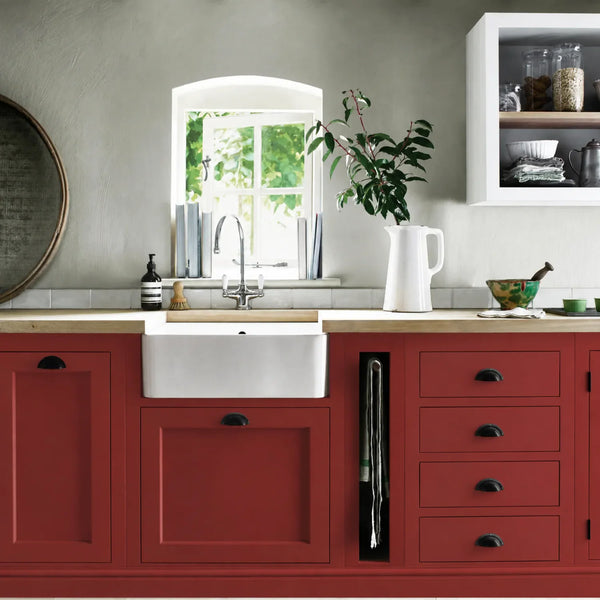 Burnham Red painted Henley kitchen cabinetry with oak worktops and a white farmhouse sink.
