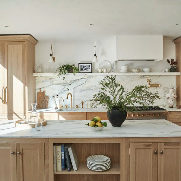 Contemporary Henley oak kitchen with marble-topped island, open shelving and brass fittings.