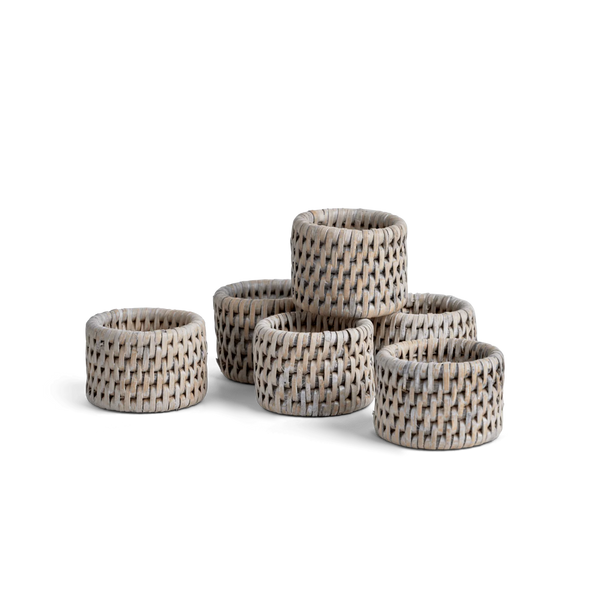 Six woven basket-style napkin rings in a natural beige and gray wicker pattern, arranged on a plain white background.