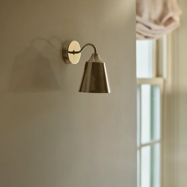 Belgrave nickel downlight wall light on cream wall next to window
