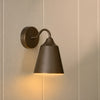 Belgrave industrial style brushed bronze wall light, light on