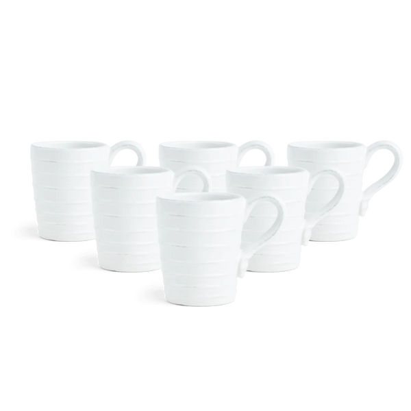 Six white ceramic mugs with a subtle horizontal ribbed texture and loop handles, arranged in a staggered row on a solid white background.