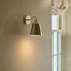 Belgrave nickel downlight wall light on cream wall next to window, light on