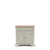 A small painted cabinet with two doors, a single drawer, brass-style round knobs, and a natural wood top, shown on a clean white background.