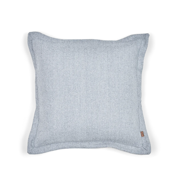 A square light blue-gray woven throw pillow with a subtle herringbone texture, shown against a plain white background.