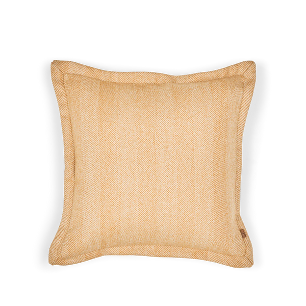 A square throw pillow in a warm beige and tan herringbone woven fabric, shown from a top-down view on a white background.