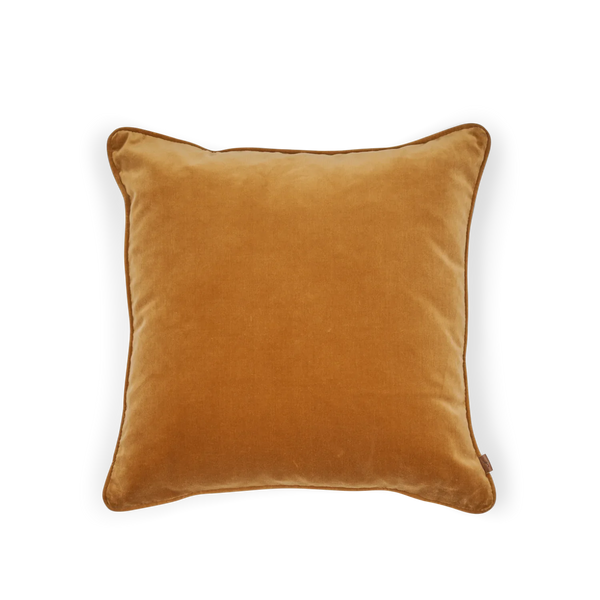A square velvet throw pillow in a warm camel brown color, shown from a top-down view on a solid white background.