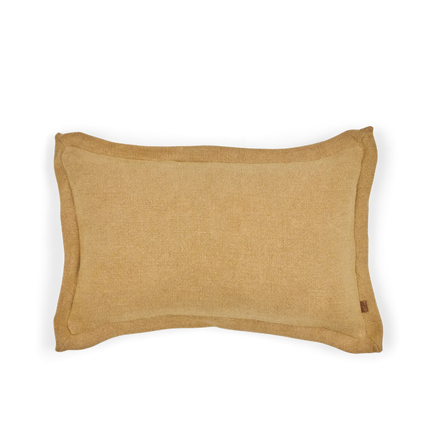 A rectangular lumbar pillow in a textured saffron yellow linen fabric, featuring a small brown leather brand tag on the lower right edge, set against a plain white background.