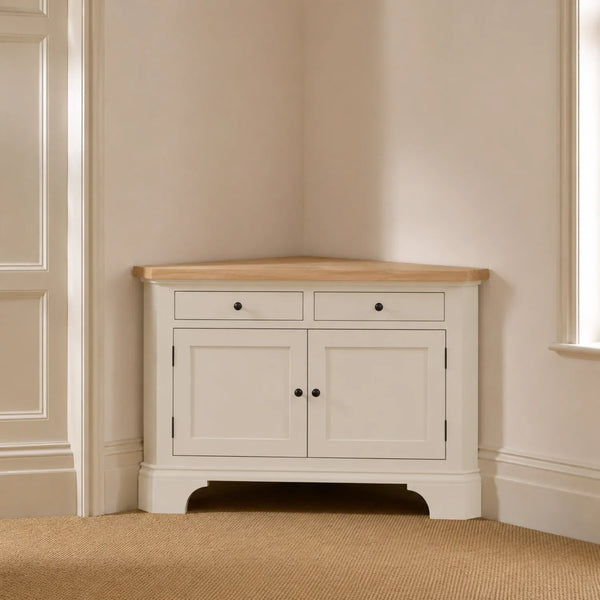 Henley 4ft Corner AV Cabinet in Silver Birch with oak top, styled in a softly lit neutral room corner.