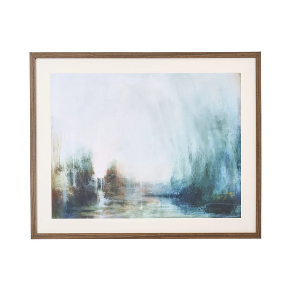 A framed abstract landscape painting featuring soft, misty brushstrokes of blue, green, and white, set within a white mat and a medium brown wooden frame.