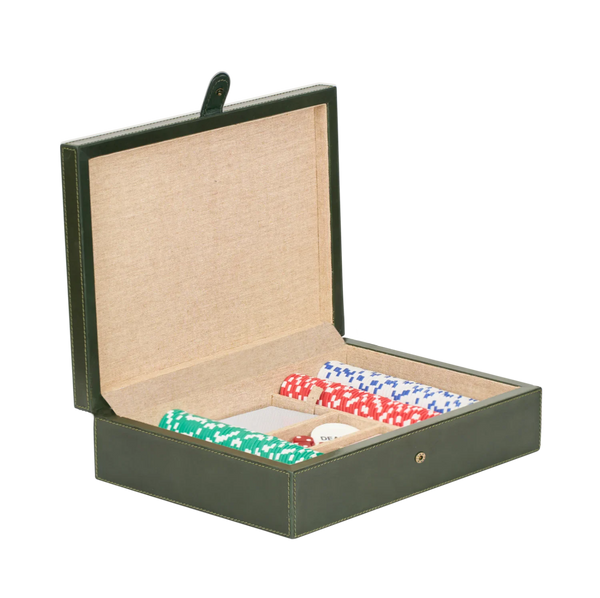 An open dark green leather poker set box with a beige fabric-lined interior, shown on a plain white background. Inside, rolled green, red, and blue patterned chips are arranged on a small white card.