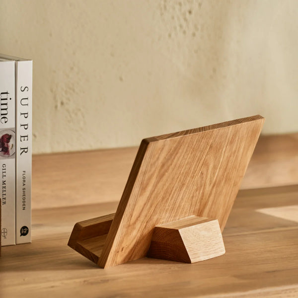 Orford white oak wooden cookbook stand, displayed on wooden counter