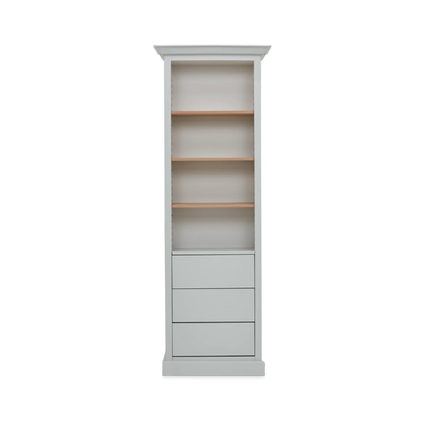 A tall, narrow bookcase with four open shelves, two of which have light natural wood backing, and a lower section with four drawers, finished in a light gray color.