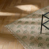 Rona rug in cactus shown with wooden parquet flooring