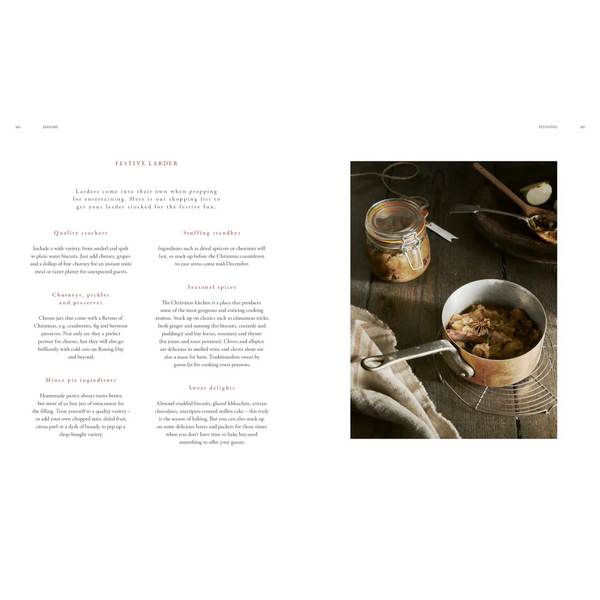 An open cookbook or recipe book spread showing the heading 'FESTIVE LADDER' with ingredient notes on the left and a styled food photography scene on the right. The right side shows a bowl of cooked food on a dark wooden table with a glass jar lid, spoon, and napkin.