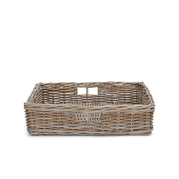 A woven natural rattan or wicker basket corner with slatted sides on a white background