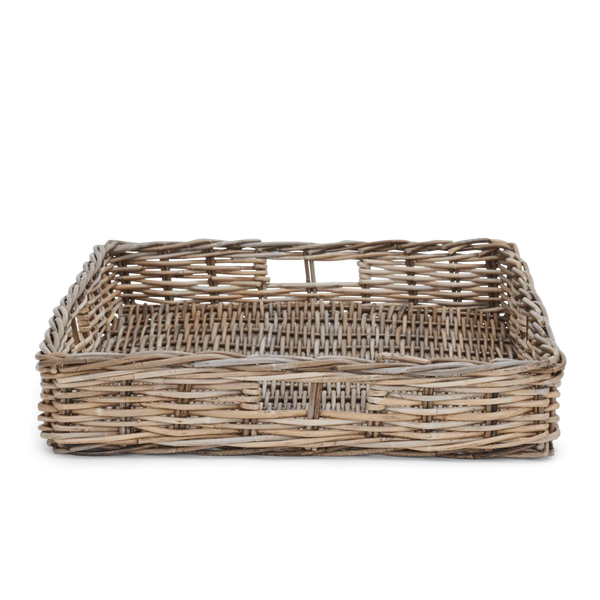 A woven natural rattan or wicker basket corner with slatted sides on a white background