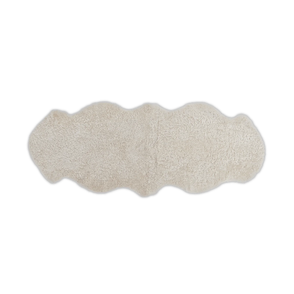 A cream-colored sheepskin rug with a natural wavy border, displayed flat against a solid white background.