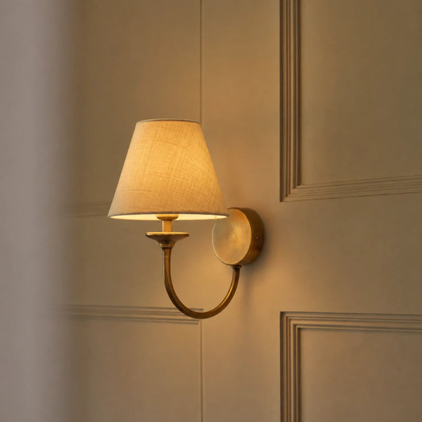 Wilton single wall light with linen shade and brass fitting, light on