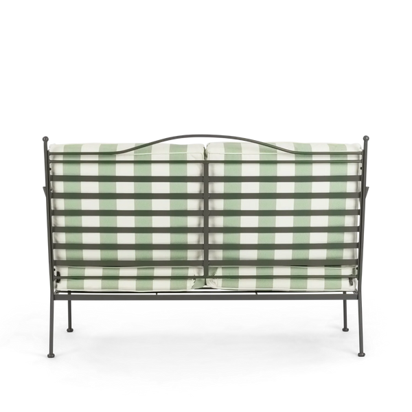 Wrought iron garden sofa with green and white checkered cushion on a white background