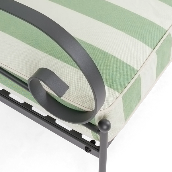 Close-up of a green and white striped cushion with black metal frame on a white background