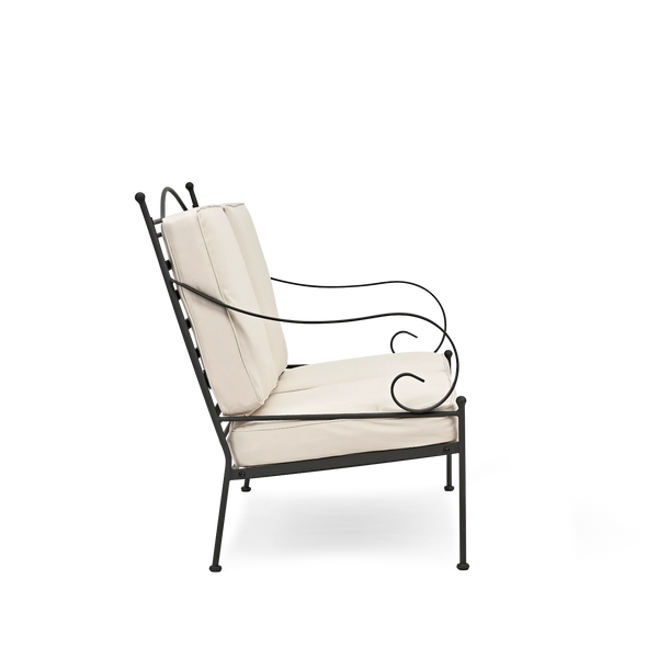 A black iron outdoor sofa with cream-colored cushions, shown from a side angle against a plain white background.