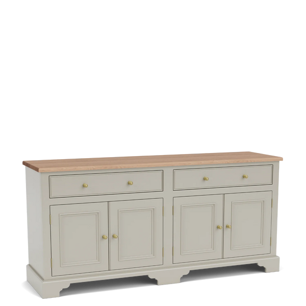 Angled view of the Chichester 6ft sideboard, with a natural oak top, painted timber frame, upper drawers, panelled cupboard doors and traditional brass handles.