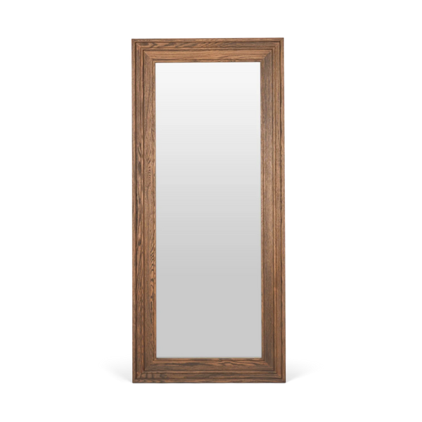 A tall, narrow rectangular wall mirror with a medium brown wood grain frame, shown against a plain white background.