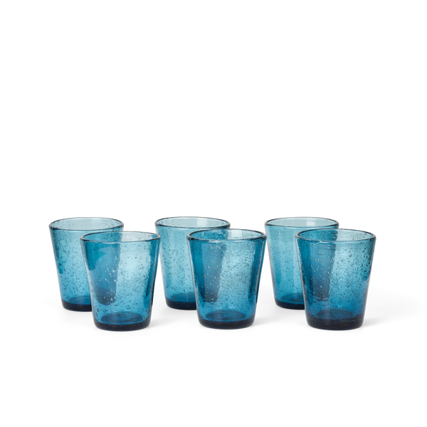 Six small blue translucent drinking glasses with a speckled bubble texture, arranged in a semi-circle on a white background.