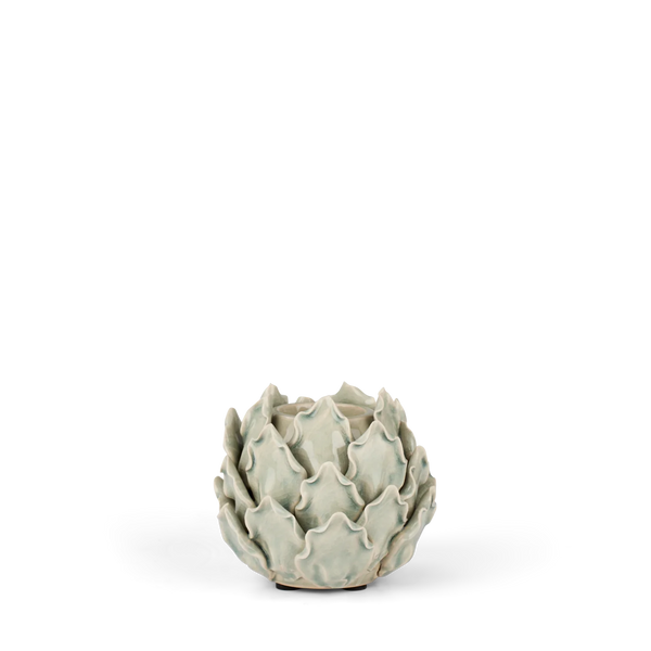 A ceramic art deco style vase sculpted in the shape of a closed artichoke, featuring a glossy pale sage green glaze on a white background.
