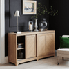 Wooden sideboard with decorative items against a dark wall
