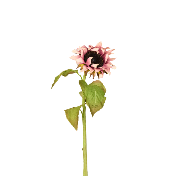 A single artificial sunflower with pink petals, a dark brown center, and green leaves on a stem, isolated on a white background.