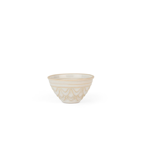 A small ceramic jelly mould bowl with a textured, embossed scalloped pattern on the lower half, finished in a warm cream or off-white glaze with a thin gold rim, set against a plain white background.