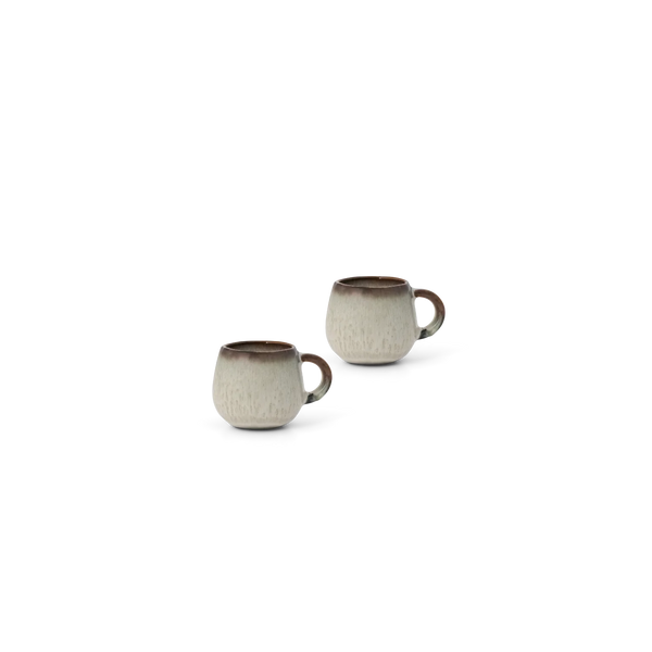 Two small ceramic mugs with a textured beige and white glaze and dark brown rims, shown on a plain white background.